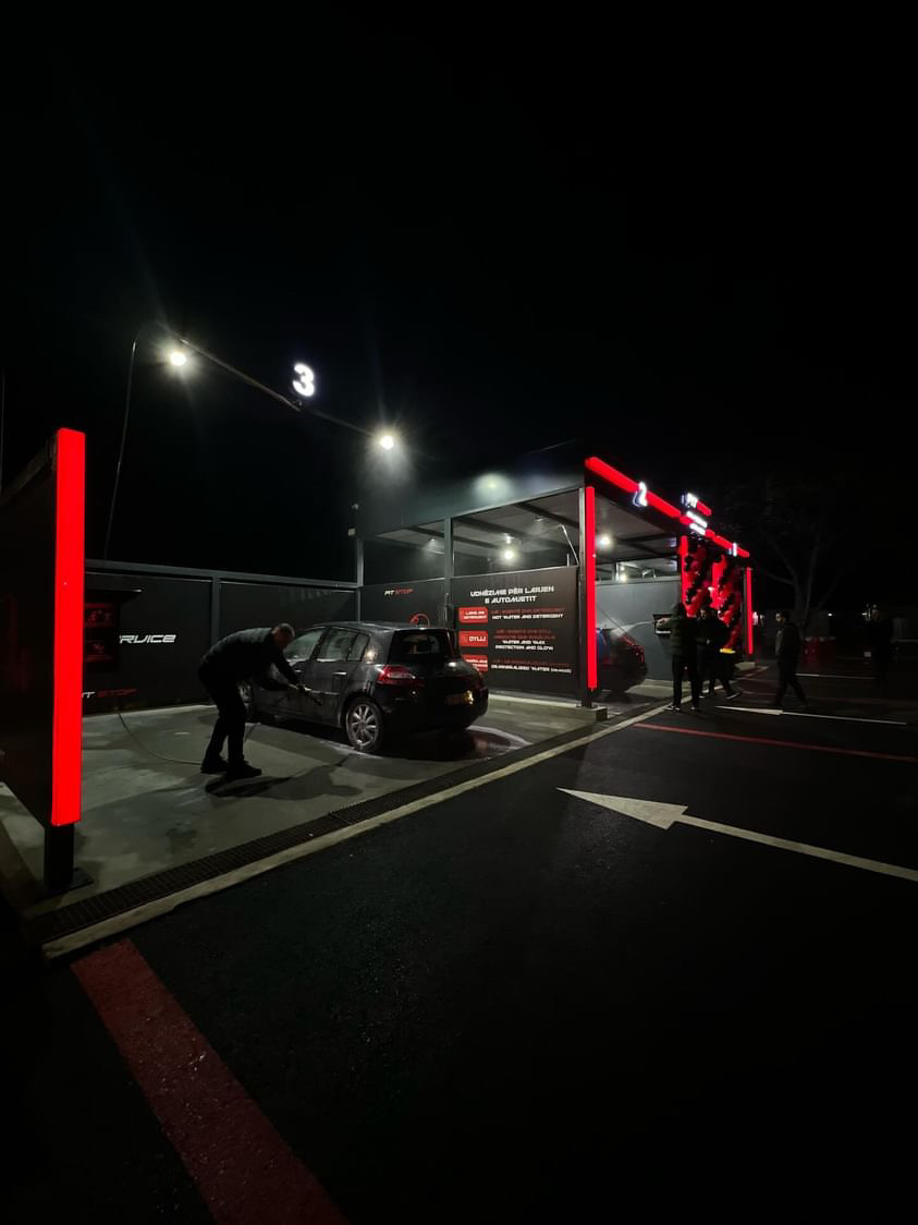 Customer washing car at night